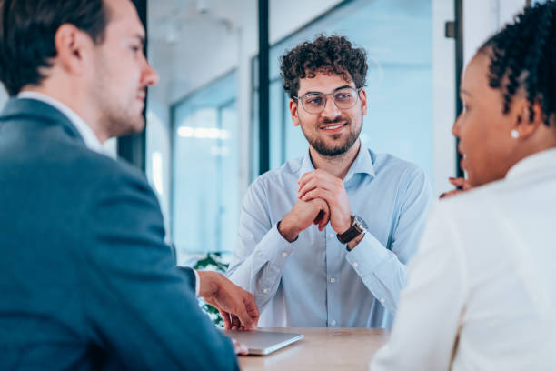 istock Group of business persons talking in the office. 2193606620