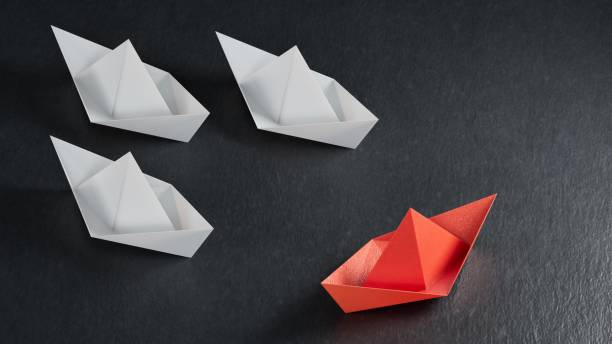 istock Different business concept.new ideas. paper art style. creative idea. red leader boat, standing out from the crowd of white boats.3D rendering on black background. 2193607000