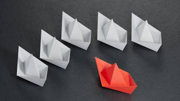 istock Different business concept.new ideas. paper art style. creative idea.Red and white paper boat. Leadership concept.3D rendering on black background. 2193607022