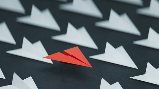 istock Different business concept.new ideas. paper art style. creative idea. red leader plane, standing out from the crowd of white planes.3D rendering on black background. 2193607024