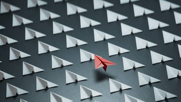 istock Different business concept.new ideas. paper art style. creative idea. red leader plane, standing out from the crowd of white planes.3D rendering on black background. 2193607038