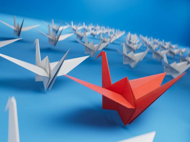 istock Different business concept.new ideas. paper art style. creative idea.red leader swan, standing out from the crowd of white swans.3D rendering on blue background. 2193607046