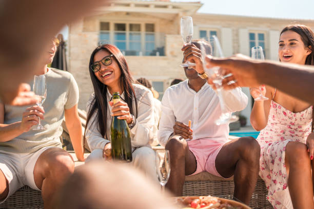 istock Diverse Friends Laughing Together at Villa Poolside 2193608255