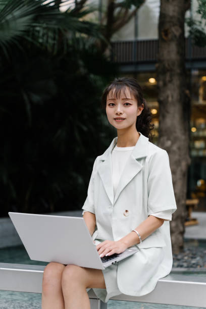 istock Asian young woman working outdoors 2193608743