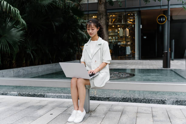 istock Asian young woman working outdoors 2193608758