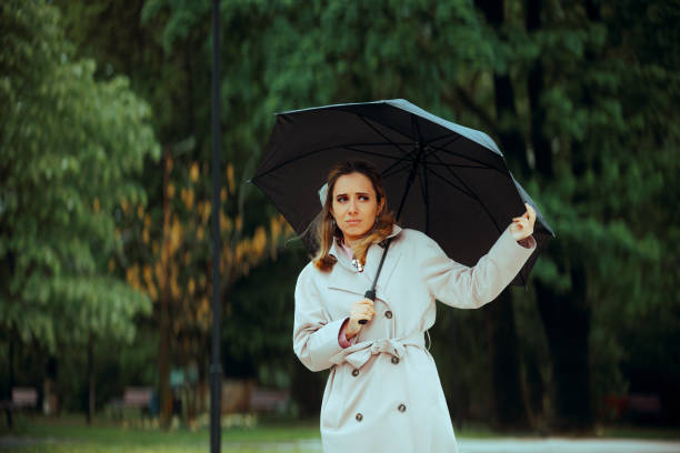 istock Woman Holding an Umbrella During Rainy Springtime 2193608899