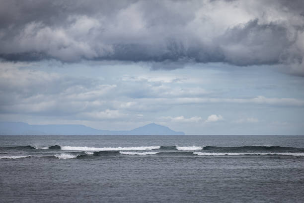 istock Surf waves with cloudy sky background at Sanur beach. 2193611029