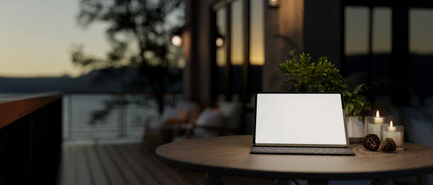 istock A digital tablet on a table on a home balcony with a nature view at dusk. 2193613020