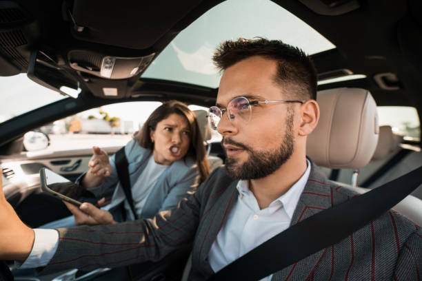 istock Angry wife arguing with cheating husband over phone messages in their car 2193615134