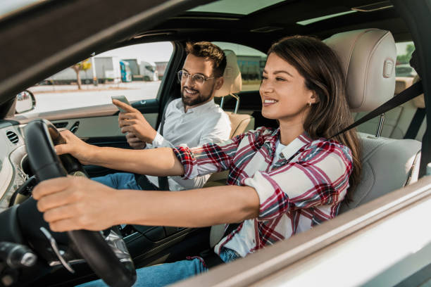 istock Woman learning to drive a car with her driving instructor next to her 2193615379