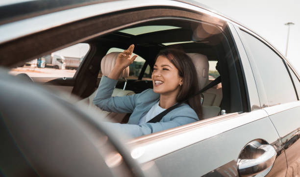 istock Woman enjoying music while driving her new car 2193615420