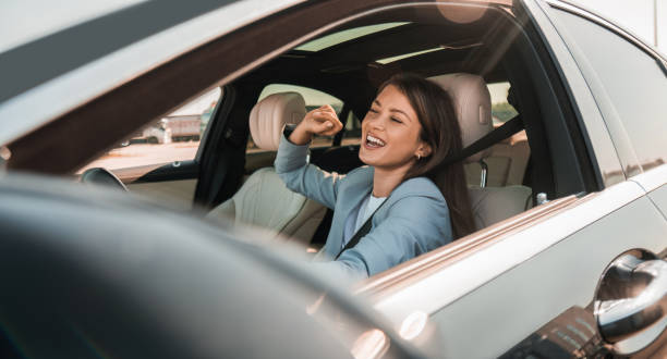 istock Woman enjoying music while driving her new car 2193615431