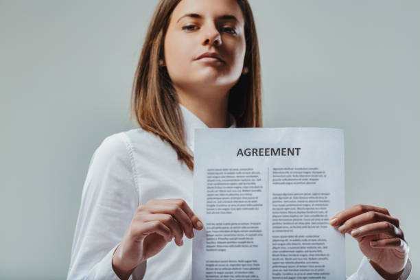 istock Businesswoman showing an agreement document to the camera 2193616610