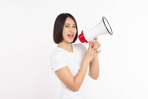 istock Asian woman smiling face holding megaphone shouting, posing isolated on white background, with copy space 2193619745