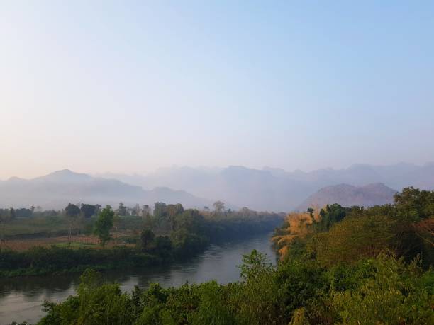 istock A tranquil and misty scene at dawn, showcasing a river winding through a lush green valley 2193623830