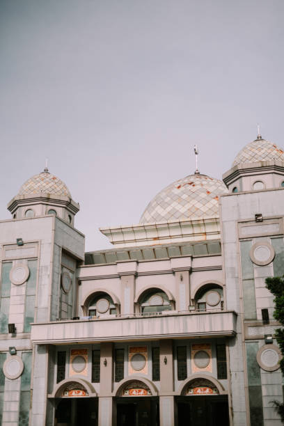 istock The serene domes of a mosque rise against a soft sky, 2193623981