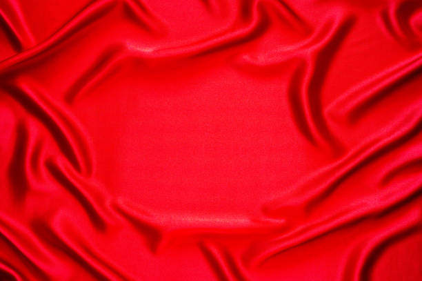 A dark red fabric texture background. Close up.
