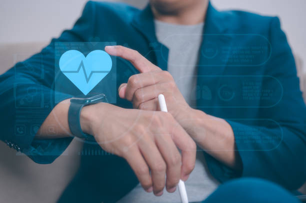 istock Businessman sitting on sofa in office using smartwatch and virtual icons, using smart watch to record exercise data health record Relieve stress, relax muscles, practice breathing, exercise, meditate 2193626368