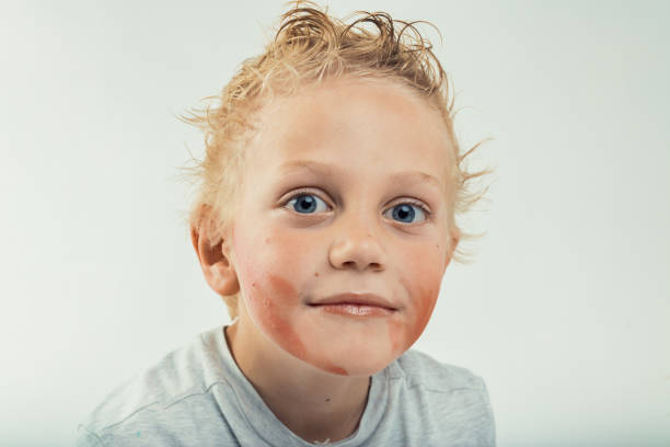 Dirty homeless boy looks through eyes full of tears. High quality photo