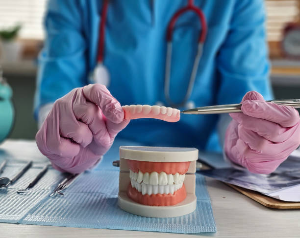 istock Dental assistant demonstrating oral care techniques with dental model and tools in clinic concept 2193626764