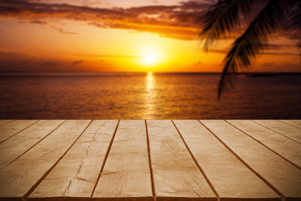 istock Empty wooden table top with tropical ocean sunset background 2193626963