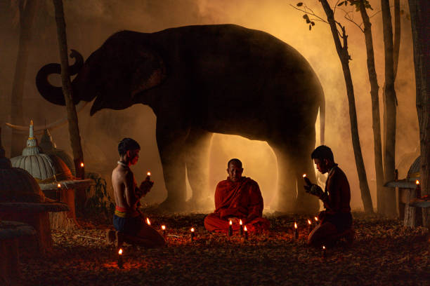 istock Monk with Muay Thai Fighters and Elephant in a Sacred Candlelit Ritual 2193630306