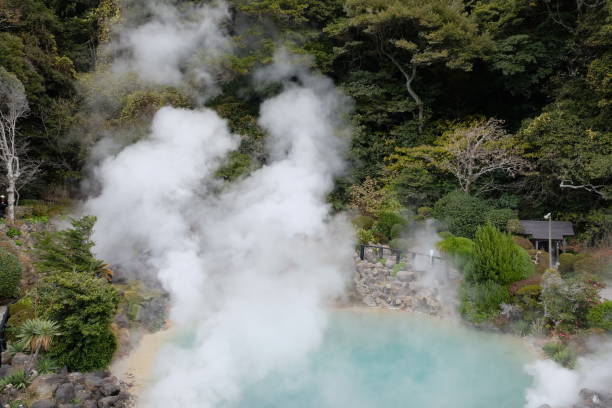 istock hot spring with steam, blue green water 2193630371