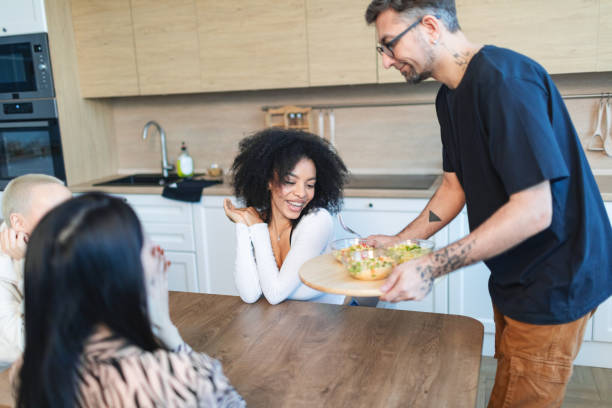 istock Friends dinning at home together with vegetable salads 2193630496