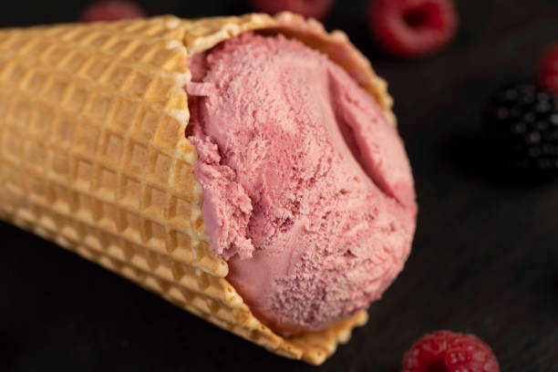istock red raspberry ice cream in a waffle cone on a black background 2193632415