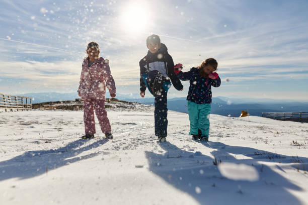 istock Happy kids enjoying winter snow 2193632540