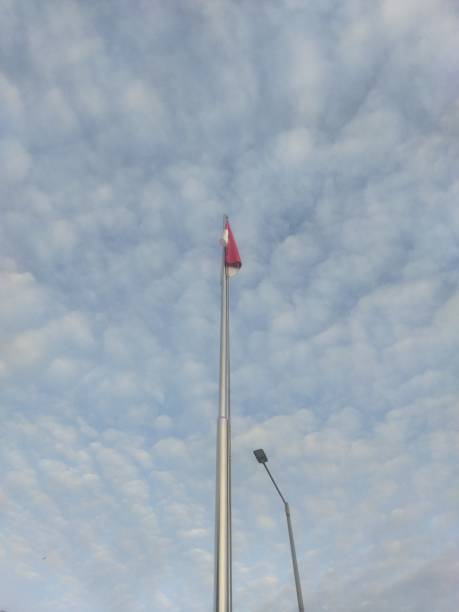 istock red and white flags againts the cloudy sky. indonesian national flag 2193632675