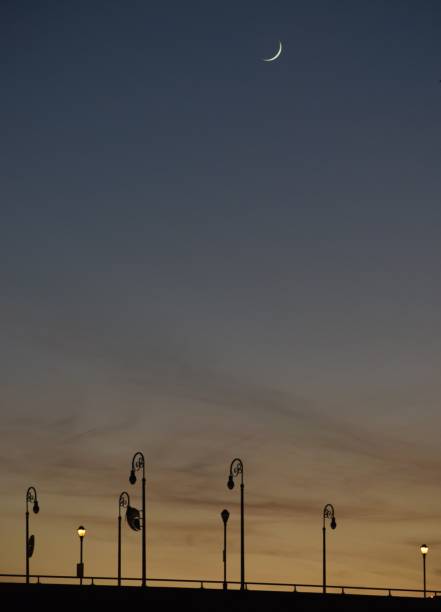 Dusky Sky with Moon and Lampposts on a Bridge