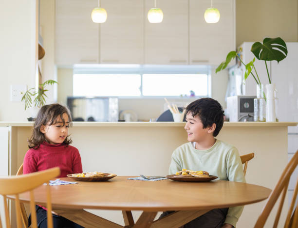 istock Kids Enjoying Pancakes at the Dining Table 2193634496