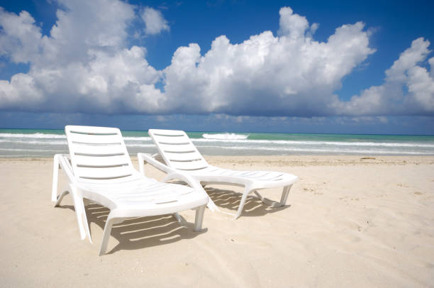 istock sunbeds and costline  at tropical beach 2193636497