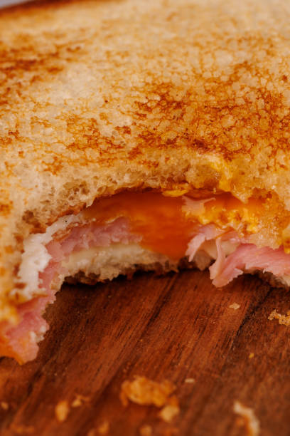 istock Delicious Egg, Ham, and Cheese Sandwich with Cherry Tomatoes on a Dark Board 2193636553