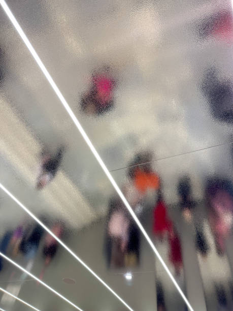 istock A blurry image of people walking in a hallway with a light shining on them 2193636718