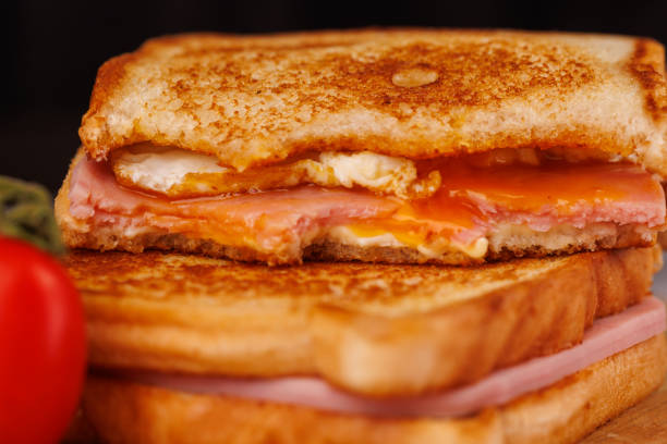 istock Tempting Cheese and Ham Sandwiches with Cherry Tomatoes and a Red Napkin 2193637088