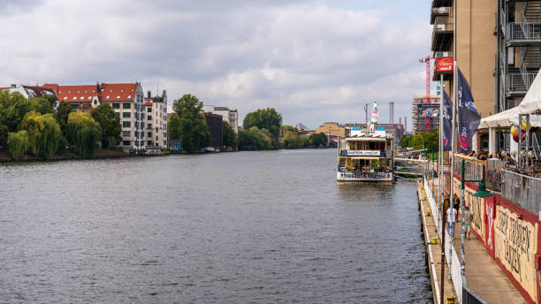 Berlin-Kreuzberg, Germany - September 12, 2021: View from the Oberbaumbruecke at the Spree River, looking north towards the city centre