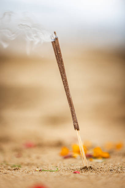 Incense is burning on Sanur beach.\nIndian culture.\nBali Island.