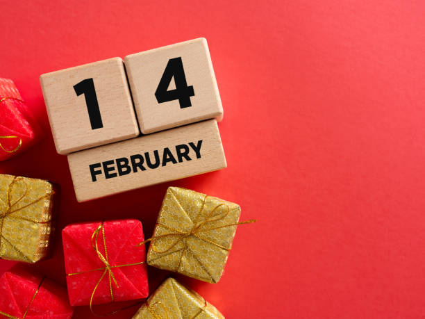istock Valentine's day composition with wooden calendar and gift boxes on red background 2193640682