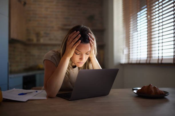 istock Displeased woman having a headache while using laptop at home. 2193640697