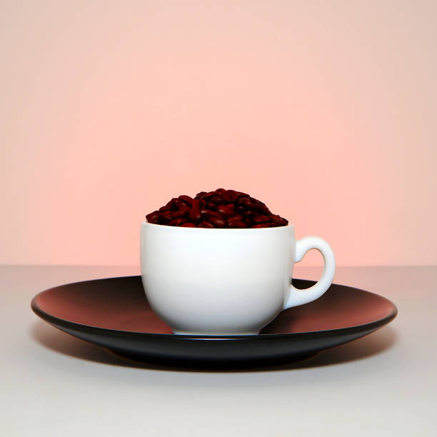 Cup and saucer with coffee beans close-up view