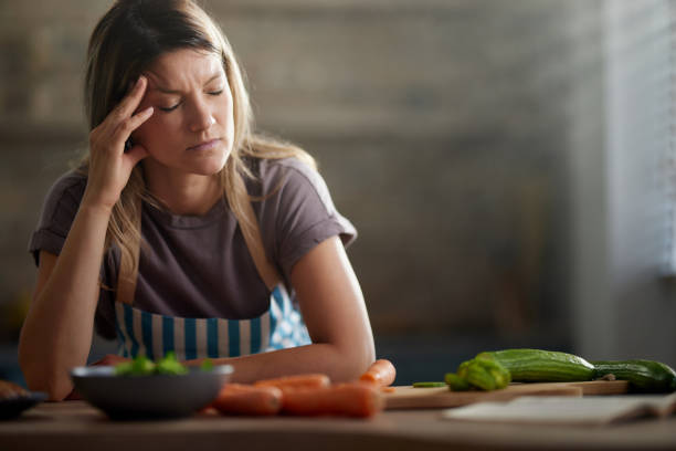 istock Displeased woman having a headache while preparing food in the kitchen. 2193641257