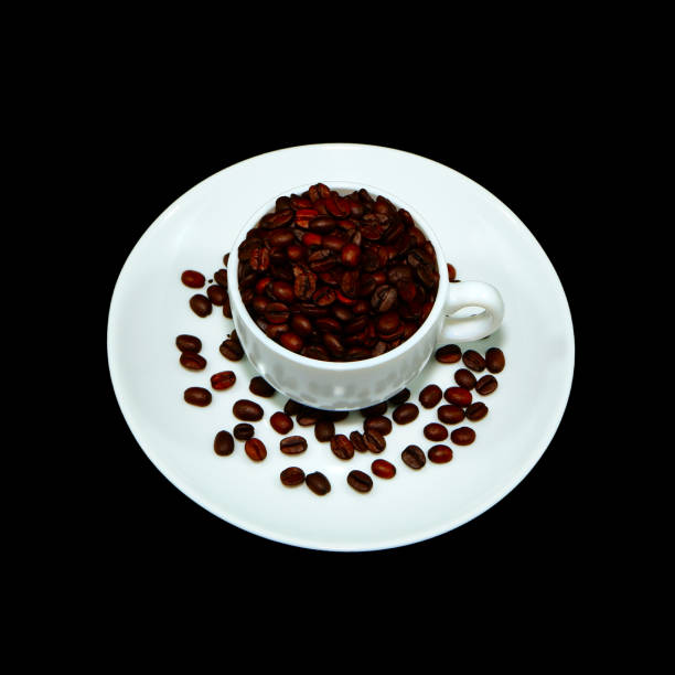 Cup and saucer isolated on black background with coffee beans close-up view concept background photography