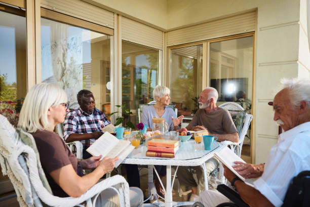 istock Diverse senior friends talking during social gathering on a terrace. 2193642422