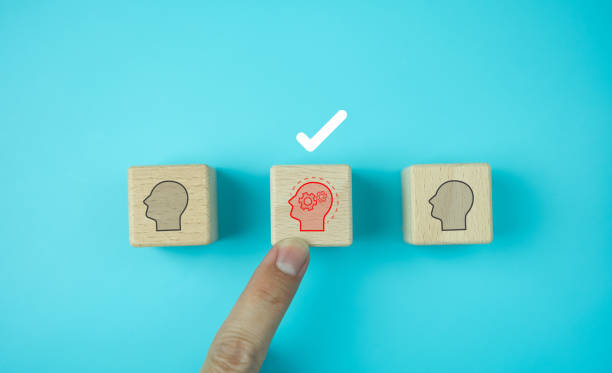 istock Male human resources hand pointing or selecting a wooden block, human figure with two gears, which means self-improvement and always learning new things, blue background, corporate recruitment concept 2193643534
