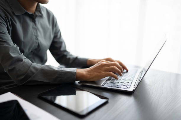 istock Business man working with laptop Hands typing  keyboard. Professional investor working new start up project. business planning in office. Technology business.. 2193644461