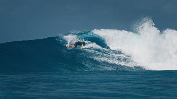 istock Professional surfer rides big ocean wave in the Maldives 2193645093