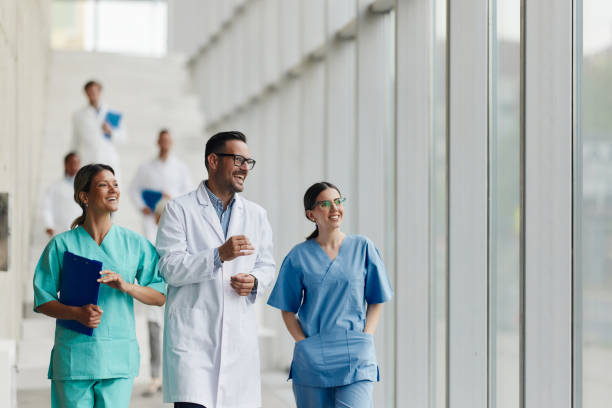 istock Happy doctors talking on the move in a hospital. 2193645333