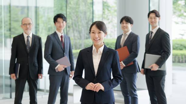 istock Asian business woman standing with a smile 2193646039